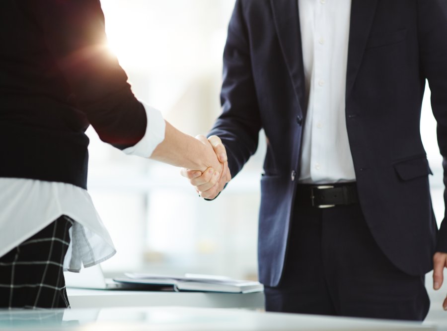 Handshake of successful business partners after negotiation and signing new contract