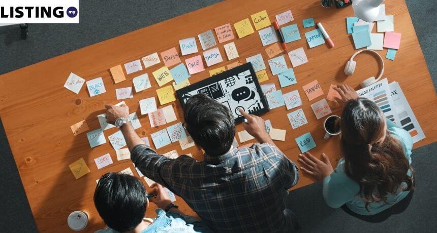 Top view of a creative content marketing agency team in Malaysia brainstorming SEO strategies and digital campaigns for 2026.