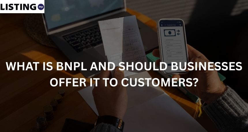 Man holding invoice and making payment with BNPL with his phone