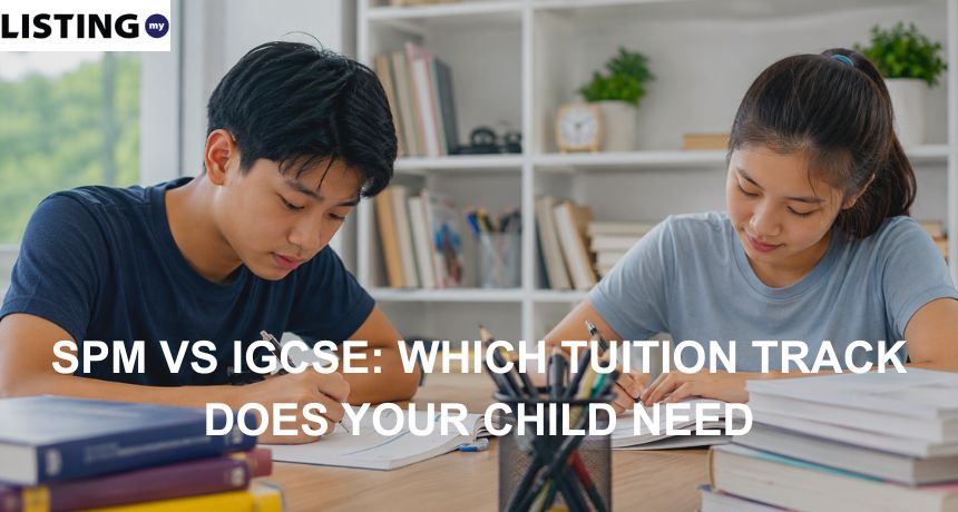 Two Malaysian teenagers study together at a desk with books and stationery in a bright learning space.