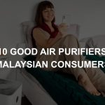 Photo of a lady using an air purifier in her room